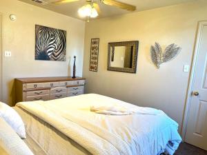 a bedroom with a bed and a dresser and a mirror at Casa Nicholas , 3 bedroom/ 2 bath with large yard in Killeen