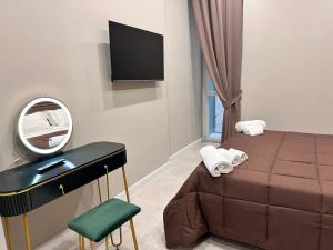 a bedroom with a bed and a mirror and a vanity at DIMORA DEL PLEBISCITO B&b in Naples