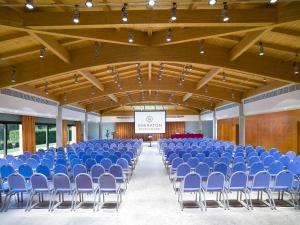 a large hall with blue chairs and a screen at Sheraton Rome Parco de Medici in Rome