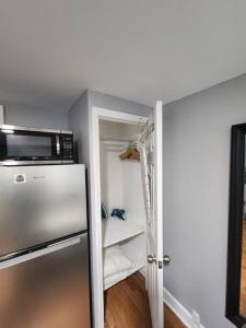 a kitchen with a refrigerator and a microwave at Cozy studio in a lovely area in Forest Hills