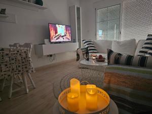 a living room with a couch and a tv at Vista la Mar in Villaricos