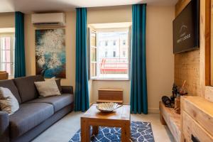 a living room with a couch and a tv at OURAL Annecy Rent Lodge in Annecy