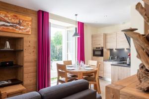a kitchen and dining room with a table and a window at CARPATES Annecy Rent Lodge in Annecy