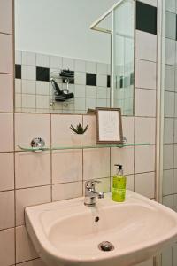 a bathroom with a sink and a mirror at City Nook Apartments Near Hauptbahnhof in Vienna