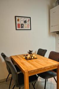 a wooden table with chairs around it with a centerpiece at City Nook Apartments Near Hauptbahnhof in Vienna