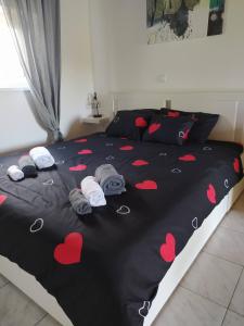 a bedroom with a bed with red hearts on it at Kuća za odmor PICCOLINA in Vinica