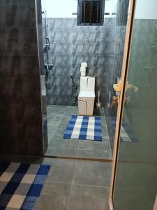 a bathroom with a shower and a toilet in it at Cozy Lodge in Grand Gaube