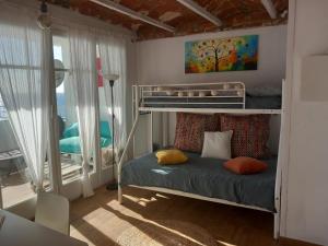 a bedroom with a bunk bed and a balcony at LOFT CANET DE MAR CERCA de BARCELONA in Canet de Mar