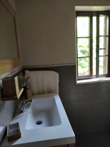 a bathroom with a sink and a window at Casa Nelito in Pedrógão Grande