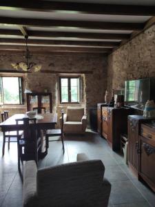 a living room with a table and a dining room at Casa Nelito in Pedrógão Grande