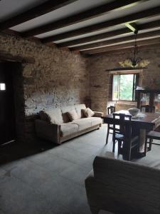 a living room with a couch and a table at Casa Nelito in Pedrógão Grande +24 photos