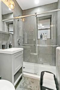 a bathroom with a shower and a sink and a toilet at Great Value Lakeview 2-Bedroom Condo - Oakdale E2 E1 rep in Chicago
