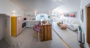 a kitchen with a dog sitting on a table in a kitchen at Elite Luxury Suites in Oia