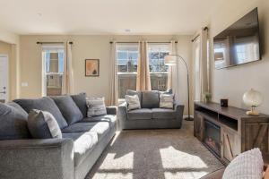 a living room with a couch and chairs and a television at Hot Tub FirePit Patio Walk To MidTown Downtown in Reno