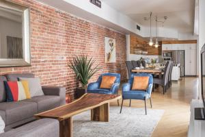 a living room with a brick wall at MTLVacationRentals - The City Chalet in Montréal