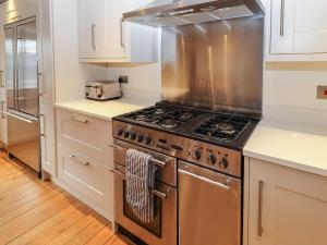 a kitchen with a stainless steel stove top oven at Mill Cottage in Hope