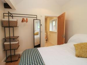 a bedroom with a bed and a mirror and a door at Border View Lodge in Welshpool