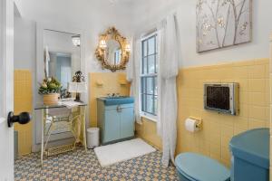 a bathroom with a blue toilet and a sink at Grand Mansion-Magnolia suite! in Fort Smith