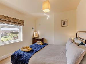 a bedroom with a bed with two towels on it at 3 Bed in Seahouses CN153 in Seahouses