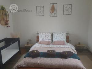 a bedroom with a bed with hats on it at Coquette Maison, Côté Château à Mutzig en Alsace in Mutzig +40 photos