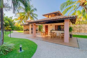 a house with a deck with a table and chairs at Beach Park Resort - Wellness in Aquiraz