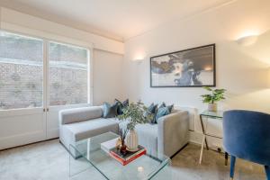 a living room with a couch and a table at Regents Park Apartments in London