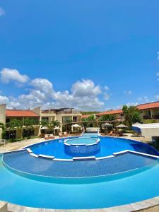 una gran piscina azul en un complejo en Solar Água Apartaments, en Pipa