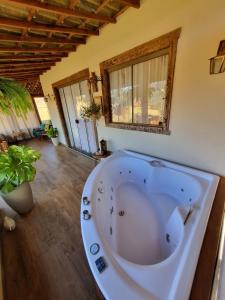 a large white bath tub in a room at Euetu na Lapinha da Serra in Santana do Riacho