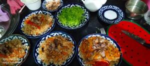 a table topped with plates of food on a table at Hotel GOLDEN DEGREZ in Bukhara +37 photos