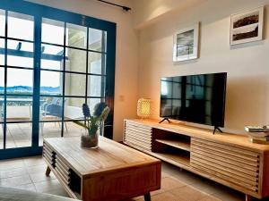 a living room with a television and a coffee table at Anna in L'Escala