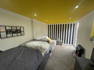 a bedroom with a bed and a large window at Beautiful place to live near Heathrow Windsor Legoland & Free Parking Onsite in Burnham