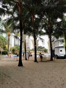 a group of palm trees on a sandy beach at Azure staycation by jane in Manila