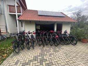 a group of bikes parked in front of a house at Rábensteiner Panzió in Fertőd