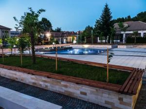 a swimming pool in the middle of a park at БЯЛАТА КЪЩА in Chakalarovo