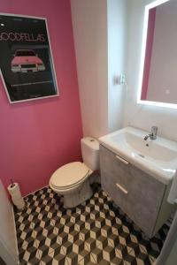 a bathroom with a white toilet and a sink at Cocon moderne - A deux pas de Bercy in Paris
