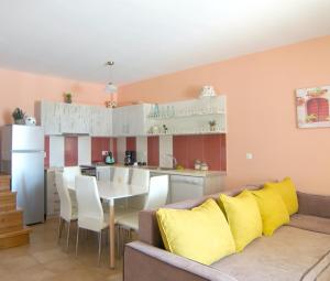a living room and kitchen with a couch and a table at Manoir Dennise Villa in Zakynthos Town