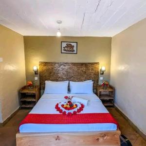 a bedroom with a large bed with a red blanket at Deka hotel Nairobi in Thika