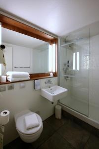 a bathroom with a toilet, sink, and shower at Campanile Aix en Provence Ouest Jas-De-Bouffan in Aix-en-Provence