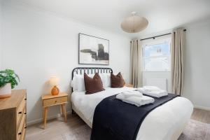 a bedroom with a bed with two towels on it at 2 Bed - Penthouse The Gatehouse by Pureserviced in Plymouth