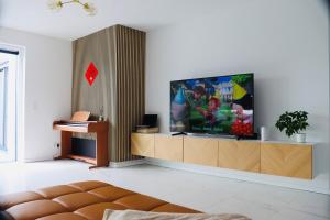 a living room with a flat screen tv on a wooden entertainment center at Komfortables Penthouse 200 qm in Langen