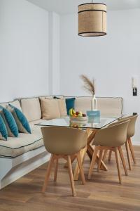 a living room with a couch and a table and chairs at Crete - Heraklion Sea View Apartment 2 in Heraklio Town