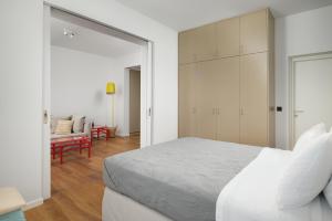 a bedroom with a bed and a living room at Crete - Heraklion Sea View Apartment 2 in Heraklio Town