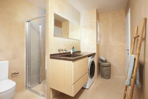 a bathroom with a sink and a shower at Crete - Heraklion Sea View Apartment 2 in Heraklio Town +15 photos