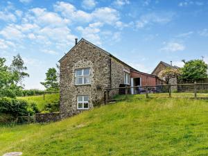 a stone house on top of a grassy hill at 2 Bed in Dulverton THREB in East Anstey