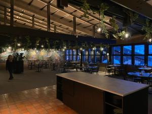 a room with tables and chairs and a wall of windows at Spåtind Fjellhotell in Nord Torpa