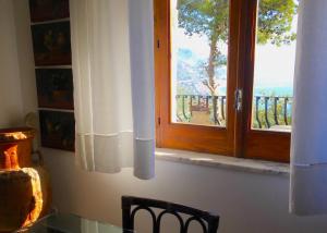 een keuken met een raam met uitzicht op de oceaan bij CASA LUDOVICA TAORMINA with Sea View Terrace in Taormina