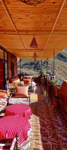 奧里卡的住宿－DAR EL HACHIMI EL IDRISSI，一个带桌椅的庭院和屋顶。