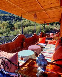 an outdoor patio with couches and tables and chairs at DAR EL HACHIMI EL IDRISSI in Ourika +33 photos