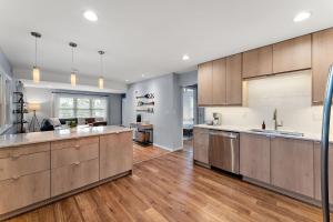 a large kitchen with wooden cabinets and wooden floors at Urban Lake Life in Minneapolis
