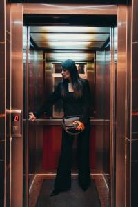 a woman with blue hair standing in a elevator at Wellness Spa Hotel Jola in Banja Luka